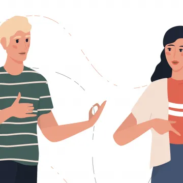 Shutterstock_Inspring Zwei Menschen sprechen in Gebärdensprache miteinander.