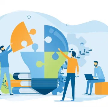 Die Illustration zeigt drei Personen, die gemeinsam an einer großen Glühbirne arbeiten, die aus Puzzleteilen zusammengesetzt ist. Im Hintergrund liegen Bücher, und eine Person nutzt einen Laptop, was Zusammenarbeit und Wissensaustausch symbolisiert.